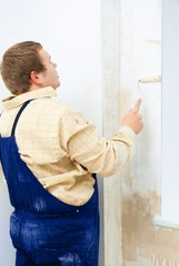 Man painting wall with roller