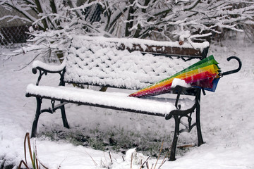 Colorful umbrella on bench