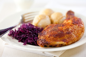 Roast chicken with potato dumplings and red cabbage