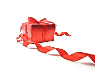 Red gift box and red ribbon on white background