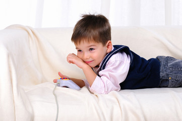 Fototapeta premium Little boy playing video games