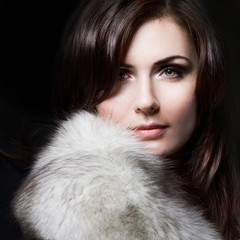 young beautiful girl in a fur collar