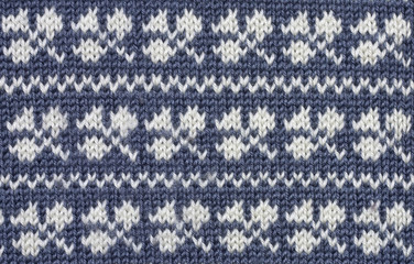 Knitted  white shamrock pattern on blue background