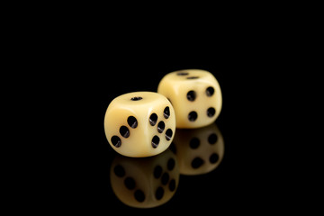 Two dice cubes on black background