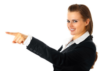 Smiling modern business woman pointing finger isolated on white.