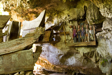 Coffins and Effigies Hang in a Cave