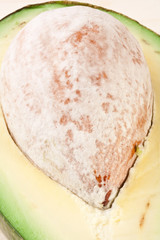half of ripe avocado fruit with seed