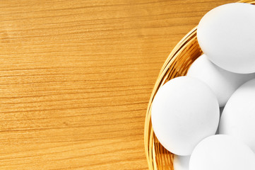Many white eggs on the wooden table
