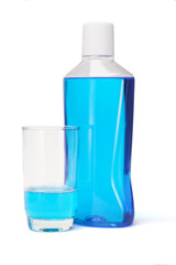 Plastic bottle and glass of mouthwash