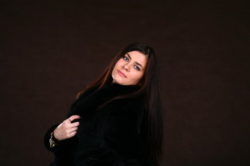 Fototapeta na wymiar Beautiful Young Woman In A Fur Coat.