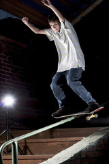 skateboarder doing a trick on the rail