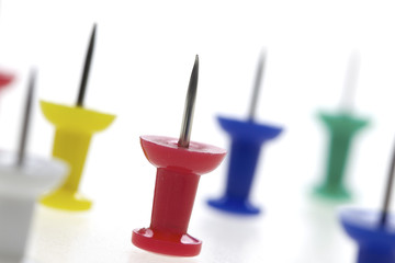 multicolored pushpins isolated on a white background