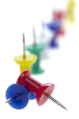 multicolored pushpins isolated on a white background