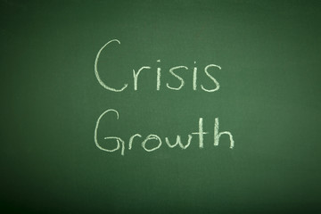 Crisis & growth hand write on chalk board
