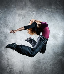 Young woman dancer jumping