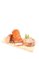 Salami, bacon, aspic, parsley on wooden board