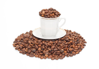 Cup with the corns of coffees on the small group of coffee