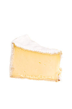 Camembert soft cheese segment over white background.