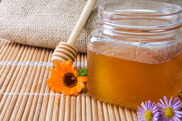 honey in glass pot near sack