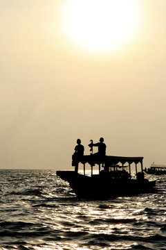 Boat on Tonle Sap lake in Cambodia at sunset