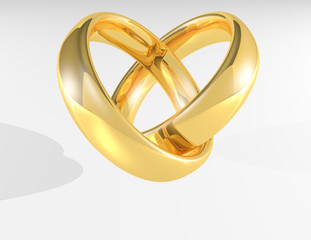 Heart made by gold shiny wedding rings