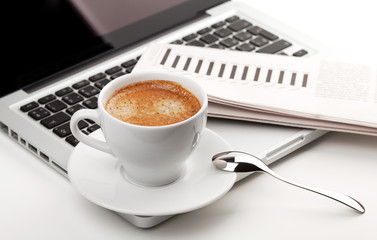 Cappuccino cup on laptop