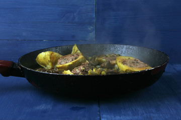 zucchini filled meat with peas over blue