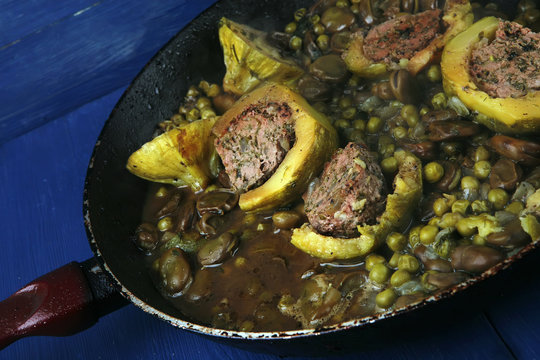 homemade cuisine: zucchini filled meat in pan over blue