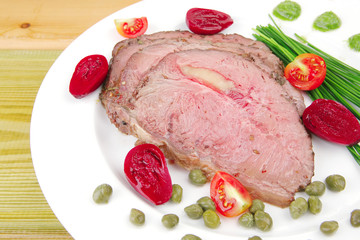 hot ham on white dish over wood