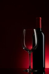 bottle with red wine and glass