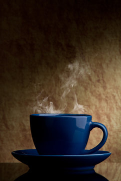 blue cup of coffee  on a old stone background.