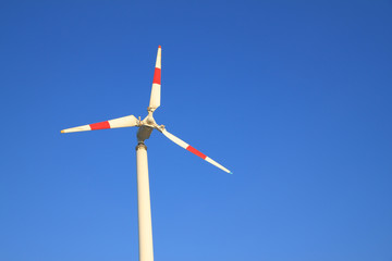 White windmill with red bar.