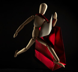 Wooden dool isolated figure with red gift Pocket.