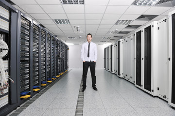 young engeneer in datacenter server room