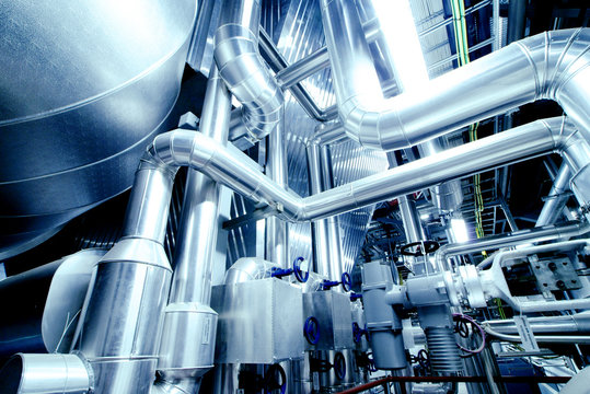 Equipment, cables and piping as found inside of a modern industr