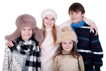 Group of teenagers in warm clothes standing together.