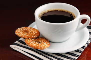 cup of coffee on saucer with cakes