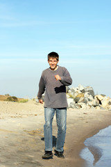 happy teenager running on the beach