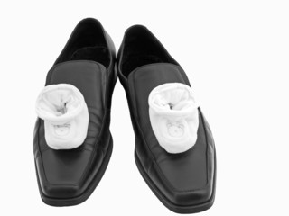 Baby shoes on Dad's shoes
