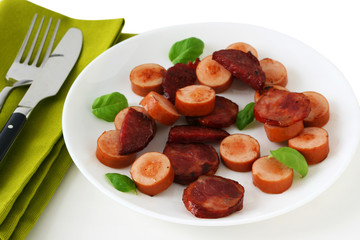 Fried sausages with basil