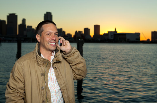 Handsome Hispanic man in a lifestyle pose with a mobile phone