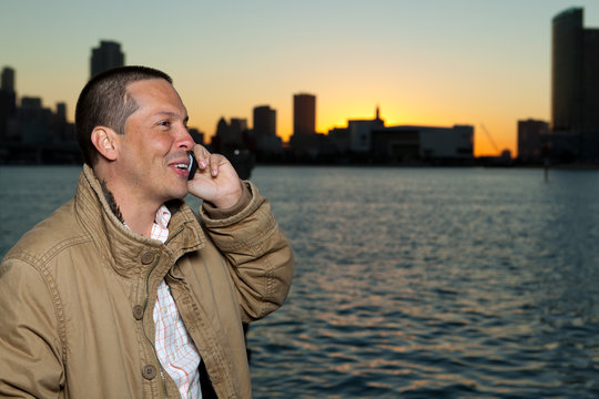 Handsome Hispanic man in a lifestyle pose with a mobile phone