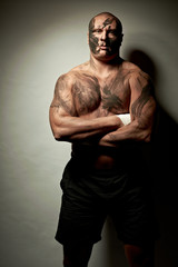 Fototapeta premium Emotional portrait of fighter. War paint on his face and body