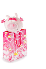 Toy piglet as christmas gift isolated on white