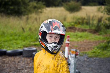 happy boy with helmet at the kart trail