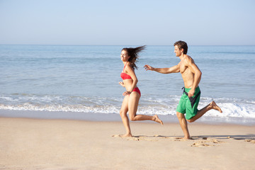 Young couple running on beach