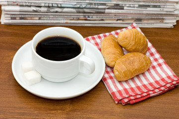 Cup from coffee and the newspaper