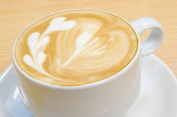 heart symbol on latte coffee cup