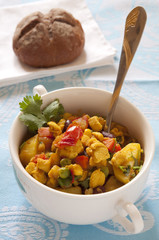 Curried turkey with potatoes, green peas and tomatoes