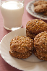 Homemade oatmeal and cinnamon cookies with glass of milk